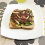 Anchovy toast with avocado and tomato