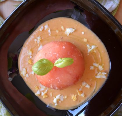 Tomato stuffed with White Tuna belly mousse on basil salmorejo