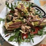 Warm salad of braised buds with tuna, anchovies and bilbaína sauce dressing