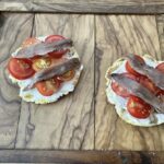 Anchovies toast on corn cakes
