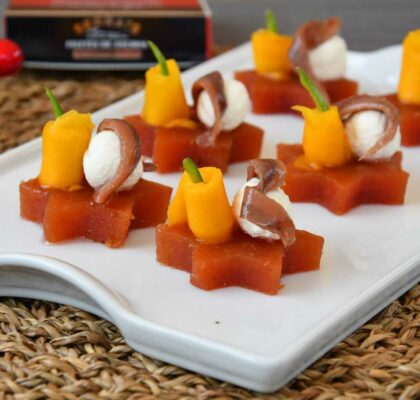 Christmas canapé of quince, cream cheese, anchovy and mango